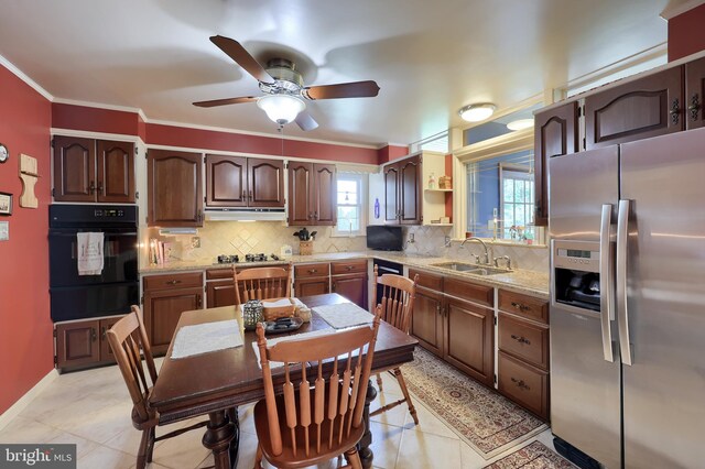 3902 Reiff Pl, Reading, PA 19606 - kitchen featuring stainless steel fridge, oven, tasteful backsplash, under cabinet range hood, and a sink