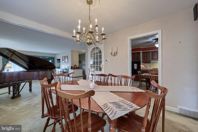 3902 Reiff Pl, Reading, PA 19606 - dining area with an inviting chandelier, light carpet, baseboards, and visible vents