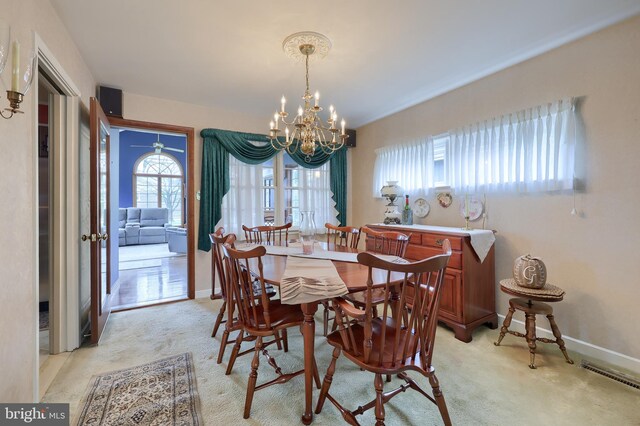 3902 Reiff Pl, Reading, PA 19606 - dining area with an inviting chandelier, baseboards, light colored carpet, and visible vents