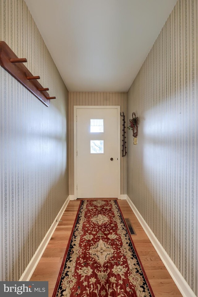3902 Reiff Pl, Reading, PA 19606 - doorway to outside with baseboards, wallpapered walls, and light wood-style flooring
