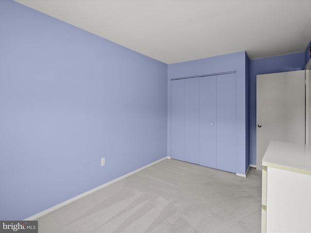 30 Drawbridge Ct, Baltimore, MD 21228 - unfurnished bedroom featuring baseboards, a closet, and light carpet