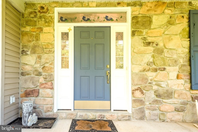 view of exterior entry featuring stone siding