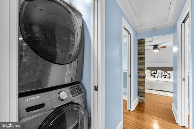 2819 S Joyce St, Arlington, VA 22202 - laundry area featuring estacked washer and dryer, attic access, wood finished floors, and baseboards