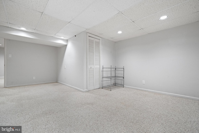 interior space featuring recessed lighting, carpet, a drop ceiling, and baseboards