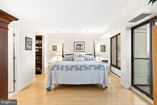2001 Hamilton St Unit 1914, Philadelphia, PA 19130 - bedroom with light wood-type flooring, a spacious closet, and access to exterior