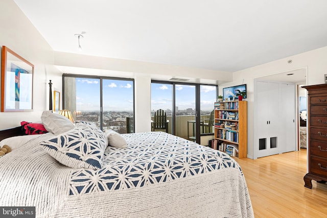 2001 Hamilton St Unit 1914, Philadelphia, PA 19130 - bedroom with access to exterior, wood finished floors, and multiple windows