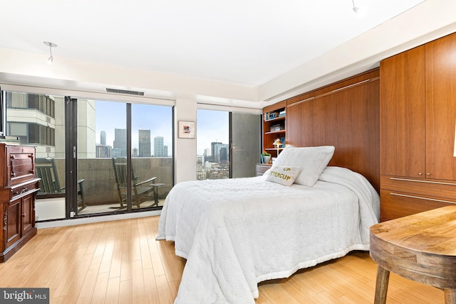 2001 Hamilton St Unit 1914, Philadelphia, PA 19130 - bedroom with a view of skyline, access to outside, and light wood-type flooring