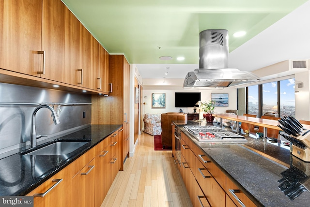2001 Hamilton St Unit 1914, Philadelphia, PA 19130 - kitchen with island range hood, stainless steel appliances, light wood-type flooring, modern cabinets, and brown cabinetry