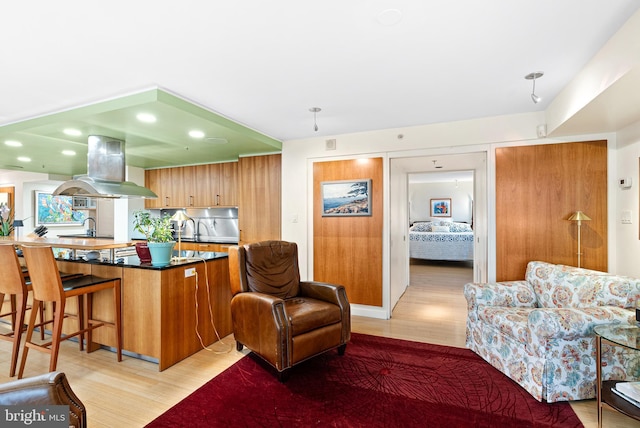 2001 Hamilton St Unit 1914, Philadelphia, PA 19130 - kitchen with island range hood, light wood-style flooring, a kitchen bar, modern cabinets, and recessed lighting