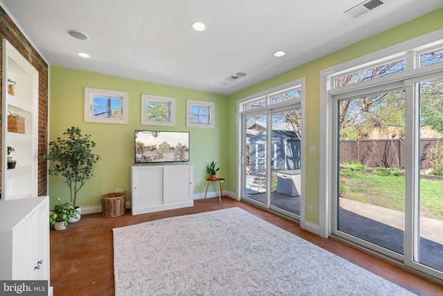 unfurnished room featuring visible vents, baseboards, recessed lighting, and finished concrete floors
