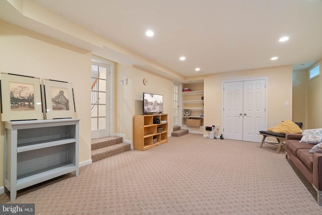 carpeted living area with built in features, baseboards, and recessed lighting