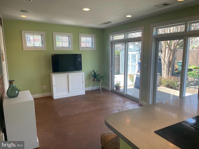 living area with concrete floors, visible vents, recessed lighting, and plenty of natural light