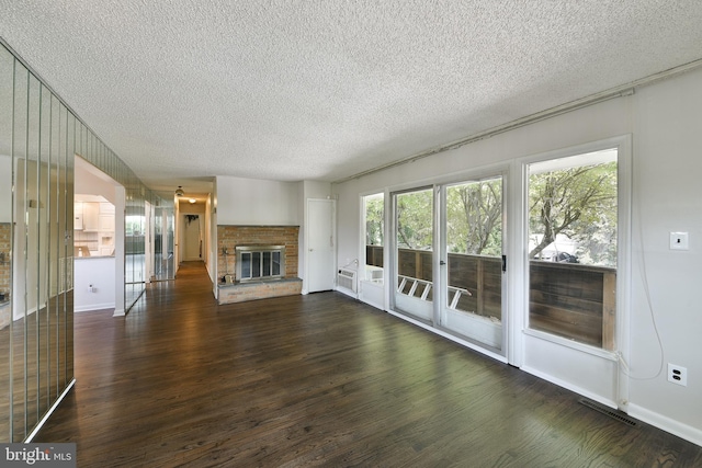 1556 Coolidge Ave, Abington, PA 19001 - unfurnished living room featuring a textured ceiling, dark wood-type flooring, and a brick fireplace