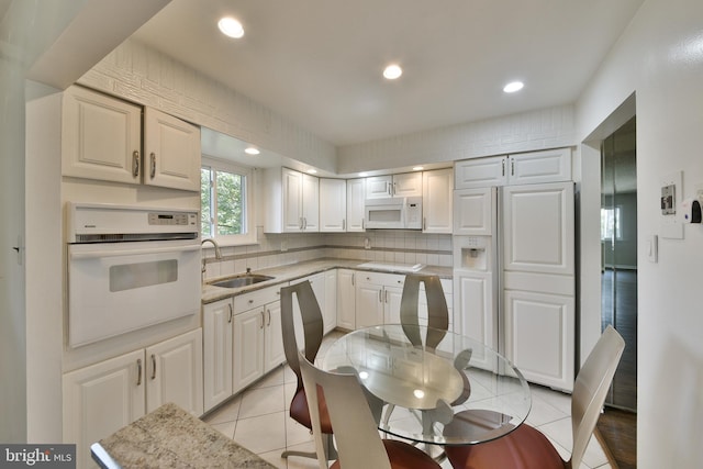 1556 Coolidge Ave, Abington, PA 19001 - kitchen with white appliances, tasteful backsplash, light tile patterned flooring, and recessed lighting