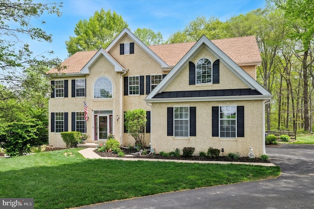 100 Fernwood Dr, Avondale, PA 19311 - colonial inspired home with a standing seam roof, stucco siding, and a front lawn