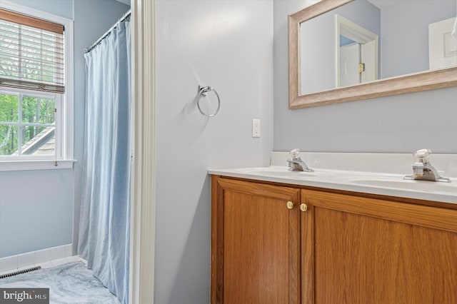 100 Fernwood Dr, Avondale, PA 19311 - full bath featuring double vanity, visible vents, curtained shower, and a sink