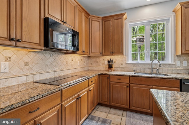 100 Fernwood Dr, Avondale, PA 19311 - kitchen with a sink, brown cabinets, black appliances, and light stone countertops