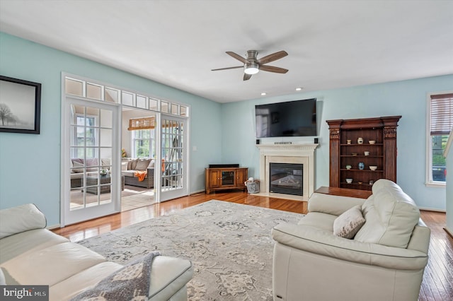 100 Fernwood Dr, Avondale, PA 19311 - living room with a healthy amount of sunlight, a fireplace with flush hearth, a ceiling fan, and wood finished floors