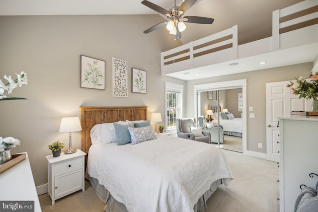 bedroom featuring high vaulted ceiling, baseboards, and light carpet