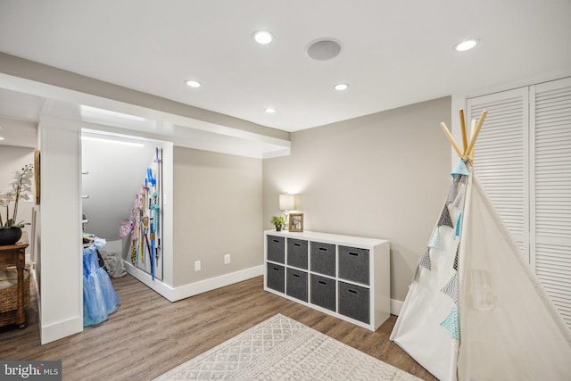recreation room with recessed lighting, baseboards, and wood finished floors