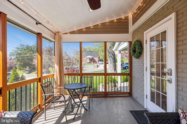 sunroom with a ceiling fan and rail lighting