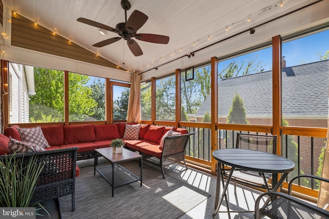 sunroom with rail lighting, a ceiling fan, and an outdoor living space