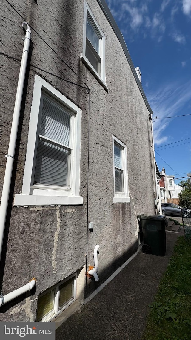 6707 Ditman St, Philadelphia, PA 19135 - view of property exterior featuring a chimney and stucco siding