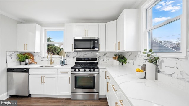 2910 Salisbury Ave, Baltimore, MD 21219 - kitchen featuring a sink, appliances with stainless steel finishes, crown molding, and light stone countertops