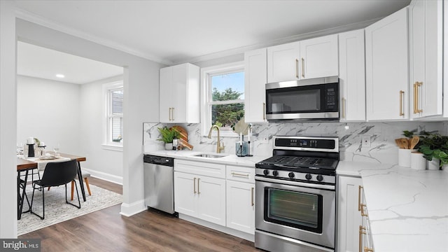 2910 Salisbury Ave, Baltimore, MD 21219 - kitchen with decorative backsplash, white cabinetry, a sink, and appliances with stainless steel finishes
