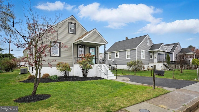 2910 Salisbury Ave, Baltimore, MD 21219 - view of front of home with central air condition unit, a front yard, and fence