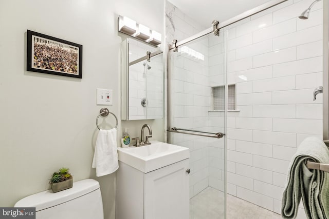 full bathroom featuring vanity, toilet, and a stall shower
