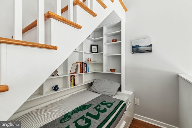 sitting room featuring baseboards and dark wood-type flooring
