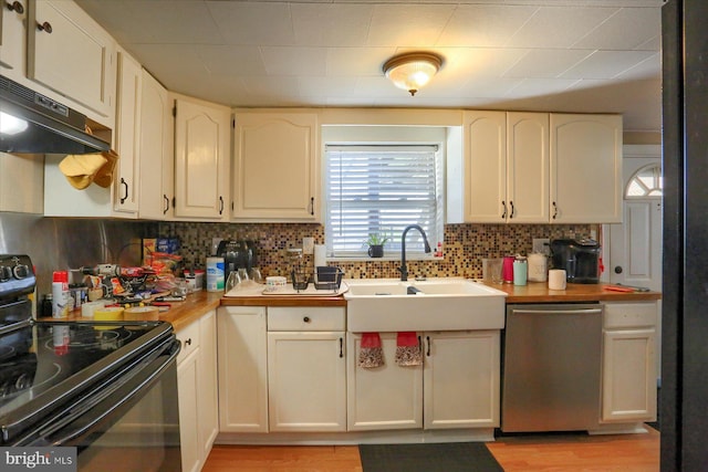 kitchen featuring white cabinets, dishwasher, under cabinet range hood, backsplash, and black range with electric stovetop