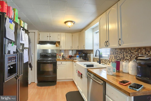 kitchen with fridge with ice dispenser, black electric range, a sink, dishwasher, and wooden counters