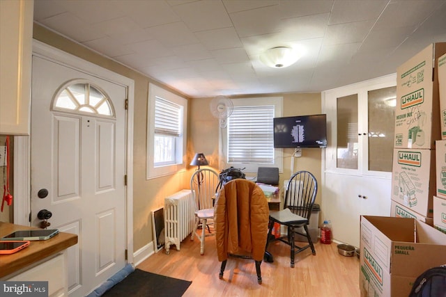 dining space featuring radiator heating unit and wood finished floors