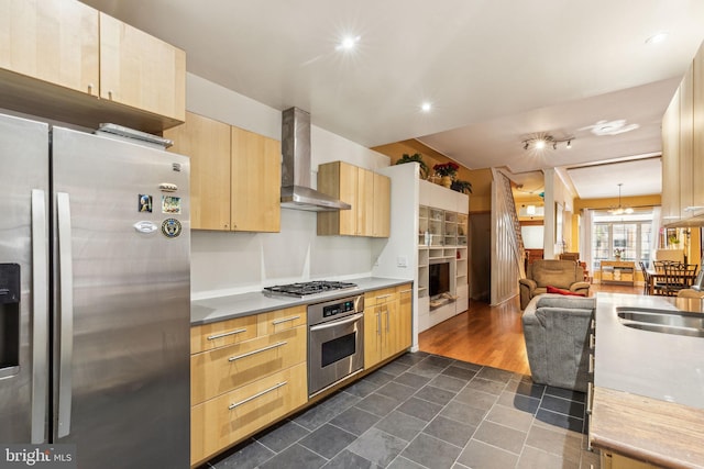 225 Buckingham Pl, Philadelphia, PA 19104 - kitchen with light brown cabinetry, appliances with stainless steel finishes, dark tile patterned flooring, open floor plan, and wall chimney exhaust hood