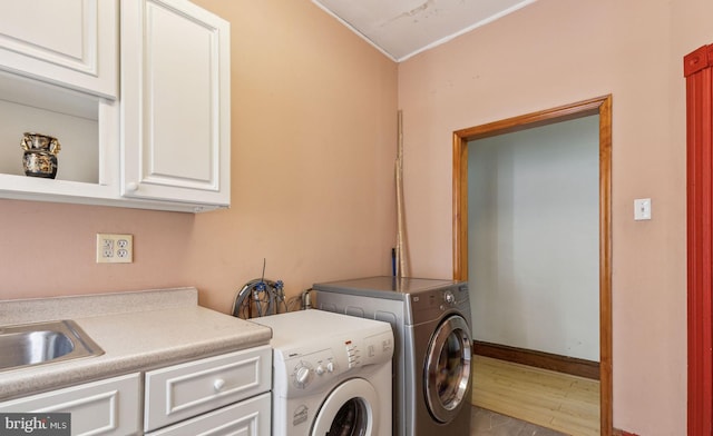 225 Buckingham Pl, Philadelphia, PA 19104 - washroom with cabinet space, washing machine and clothes dryer, a sink, baseboards, and wood finished floors