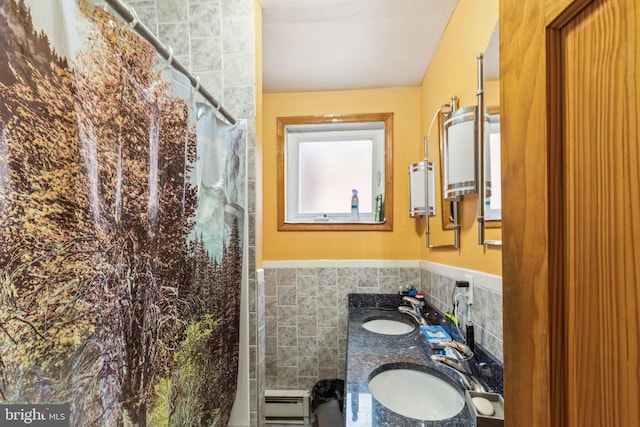 225 Buckingham Pl, Philadelphia, PA 19104 - bathroom featuring a shower with curtain, tile walls, a sink, and a wainscoted wall