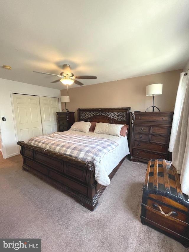 carpeted bedroom with baseboards, ceiling fan, and a closet