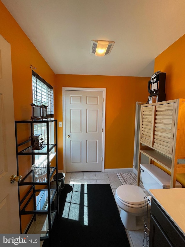 bathroom featuring visible vents, baseboards, tile patterned floors, vanity, and toilet