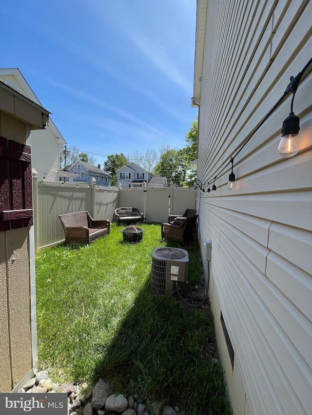 view of yard featuring fence and cooling unit