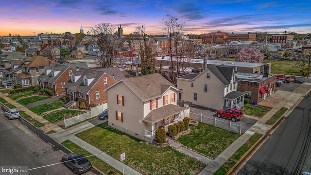 aerial view at dusk featuring a residential view
