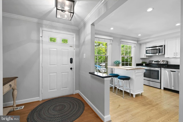 10945 Harpers Square Ct, Reston, VA 20191 - foyer entrance with crown molding, light wood-style flooring, baseboards, and recessed lighting
