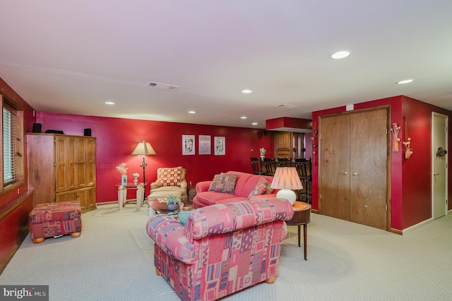 carpeted living area with visible vents, recessed lighting, and baseboards