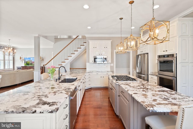 43005 Running Ridge Way, Leesburg, VA 20176 - kitchen with a chandelier, stainless steel appliances, crown molding, a sink, and white cabinets