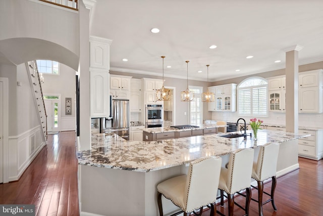 43005 Running Ridge Way, Leesburg, VA 20176 - kitchen featuring a sink, stainless steel appliances, a large island, healthy amount of natural light, and crown molding