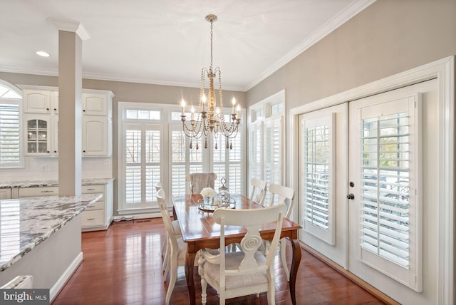 43005 Running Ridge Way, Leesburg, VA 20176 - dining space with healthy amount of natural light, wood finished floors, crown molding, a chandelier, and french doors