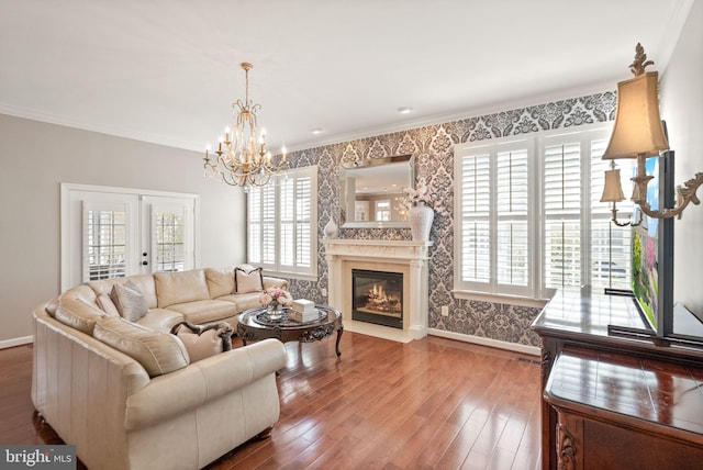 43005 Running Ridge Way, Leesburg, VA 20176 - living room with healthy amount of natural light, a chandelier, baseboards, wood finished floors, and ornamental molding