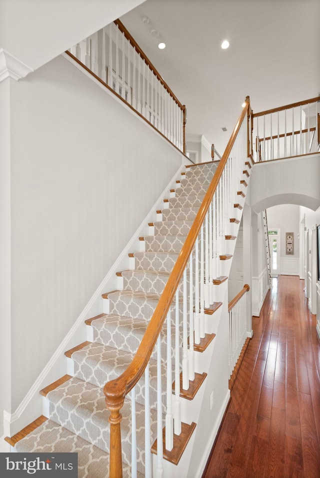 43005 Running Ridge Way, Leesburg, VA 20176 - stairs featuring arched walkways, hardwood / wood-style flooring, recessed lighting, and baseboards