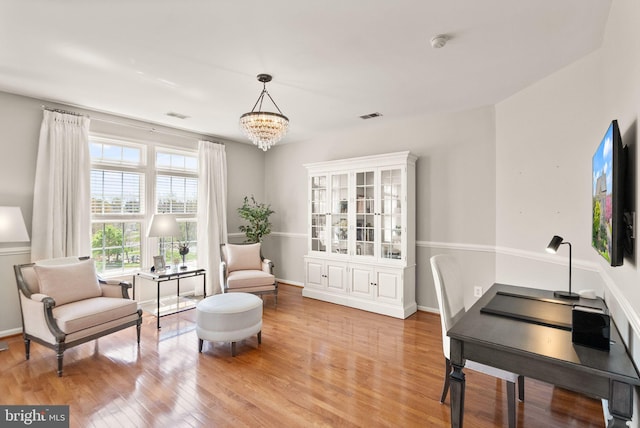 43005 Running Ridge Way, Leesburg, VA 20176 - living area with light wood-type flooring, a chandelier, and baseboards